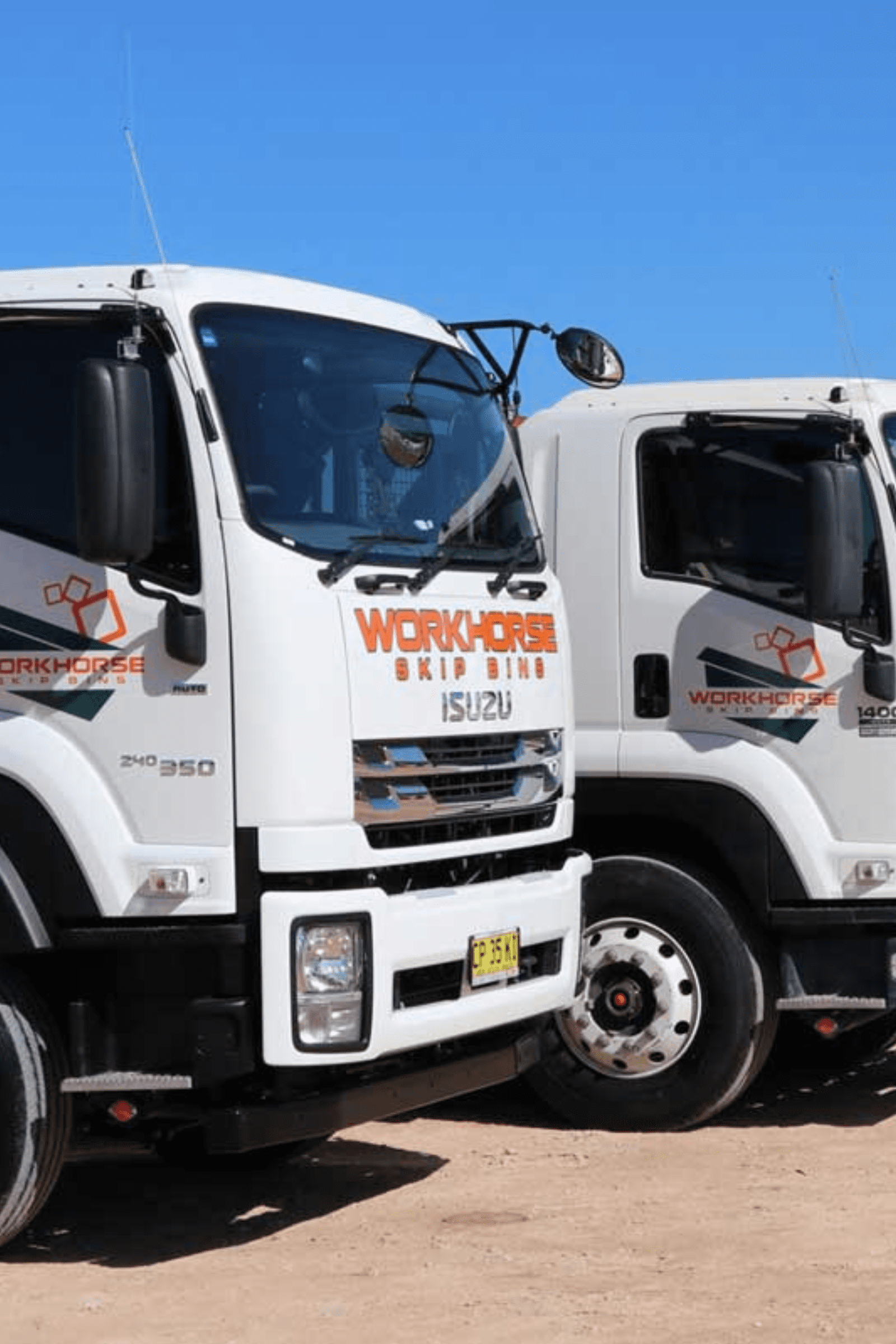 Untitled design - 2024-07-30T101810.307 Fleet of Workhorse trucks lined up on a construction site, ready for skip bin booking.
